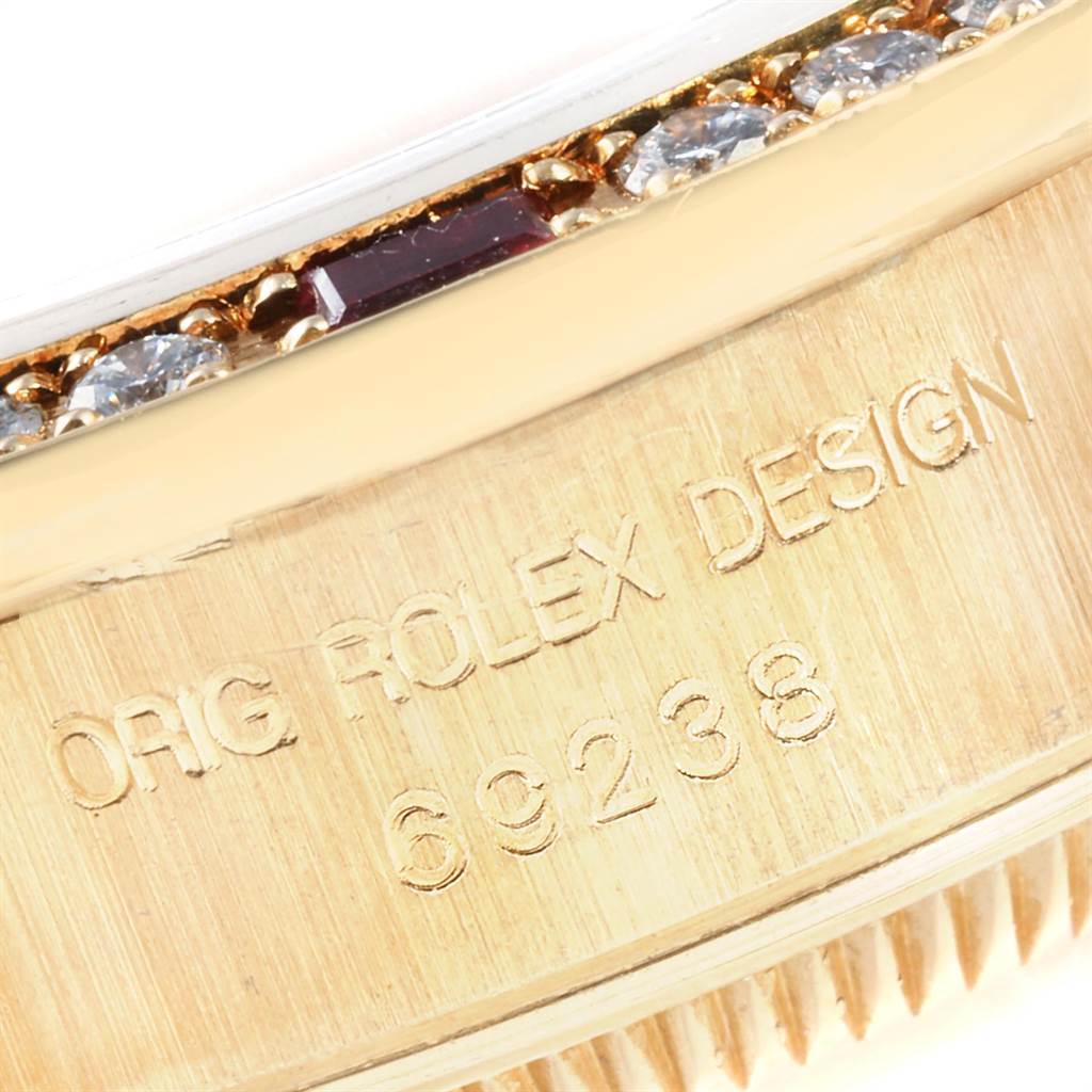 This close-up angle of a Rolex President 69238 Women
s Yellow Gold Champagne Dial 69238 Women
s Yellow Gold Champagne Dial watch focuses on the engraved serial number and diamond-encrusted bezel.