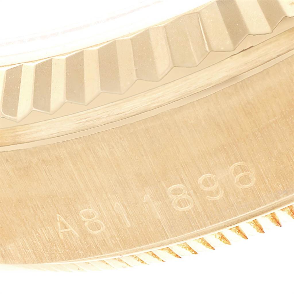 This close-up image shows the Rolex President 78278 Women
s Yellow Gold White Dial 78278 Women
s Yellow Gold White Dial model
s fluted bezel and part of the engraved serial number.