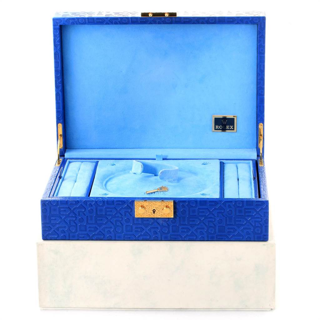 This image shows an open blue Rolex President 178288 Women's Yellow Gold Mother of Pearl Dial 178288 Women's Yellow Gold Mother of Pearl Dial model watch box with a compartment for the watch and a key inside.