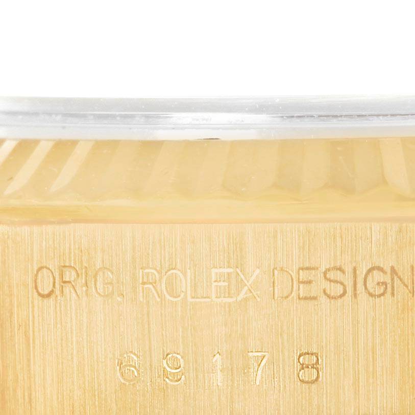 This close-up image shows the engraved case side of a Rolex President 69178 Women's Yellow Gold Champagne Dial 69178 Women's Yellow Gold Champagne Dial watch, highlighting its design details.