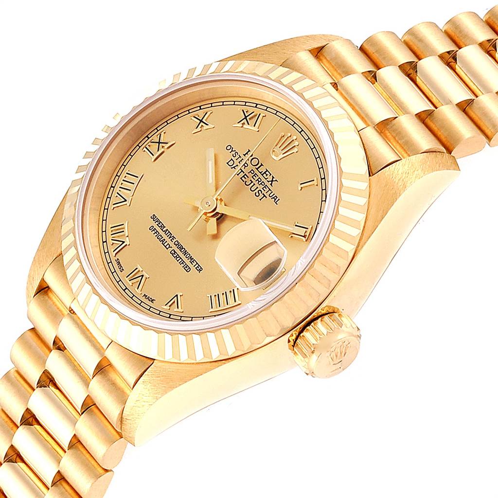 This image shows a Rolex President 69178 Women's Yellow Gold Champagne Dial 69178 Women's Yellow Gold Champagne Dial model watch at an angle revealing the dial, bezel, crown, and part of the bracelet.