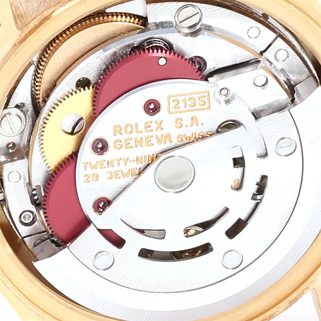 This close-up image shows the inner mechanical movement of a Rolex President 69178 Women's Yellow Gold Champagne Dial 69178 Women's Yellow Gold Champagne Dial model watch, highlighting gears and components.