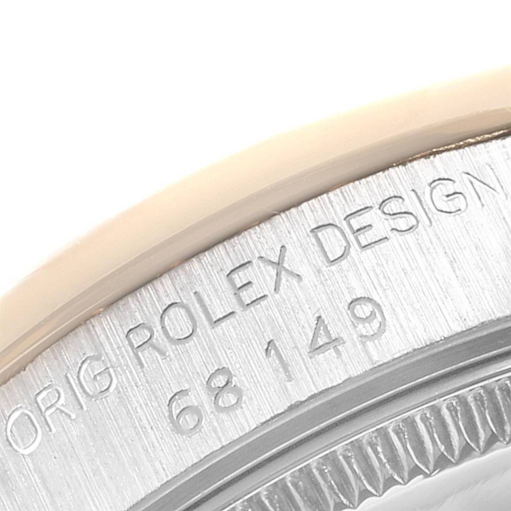 This image shows a close-up of the engraved side of the Rolex President 68149 Women's White Gold Beige Dial 68149 Women's White Gold Beige Dial watch case, displaying the model number and "ROLEX DESIGN."