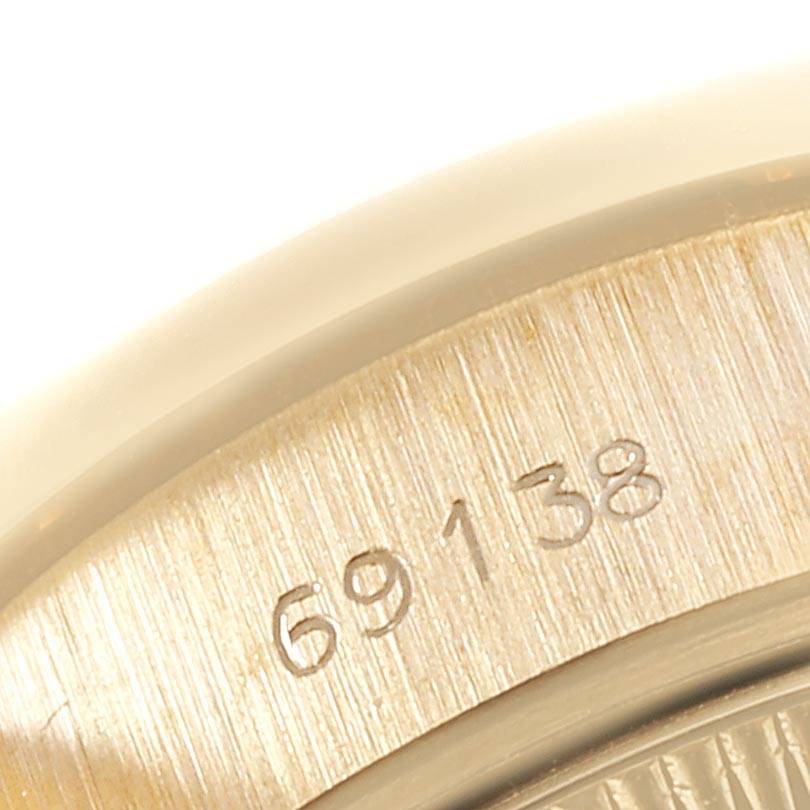 This close-up image shows the engraved model number "69138" on the case of the Rolex President 69138 Women
s Yellow Gold Champagne Dial 69138 Women
s Yellow Gold Champagne Dial watch.