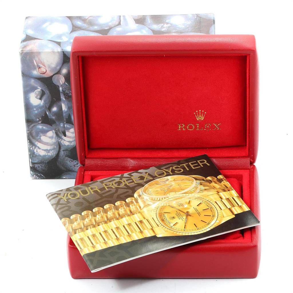 The image shows the packaging for a Rolex President 69138 Women
s Yellow Gold Champagne Dial 69138 Women
s Yellow Gold Champagne Dial model watch, including the red box and brochure.