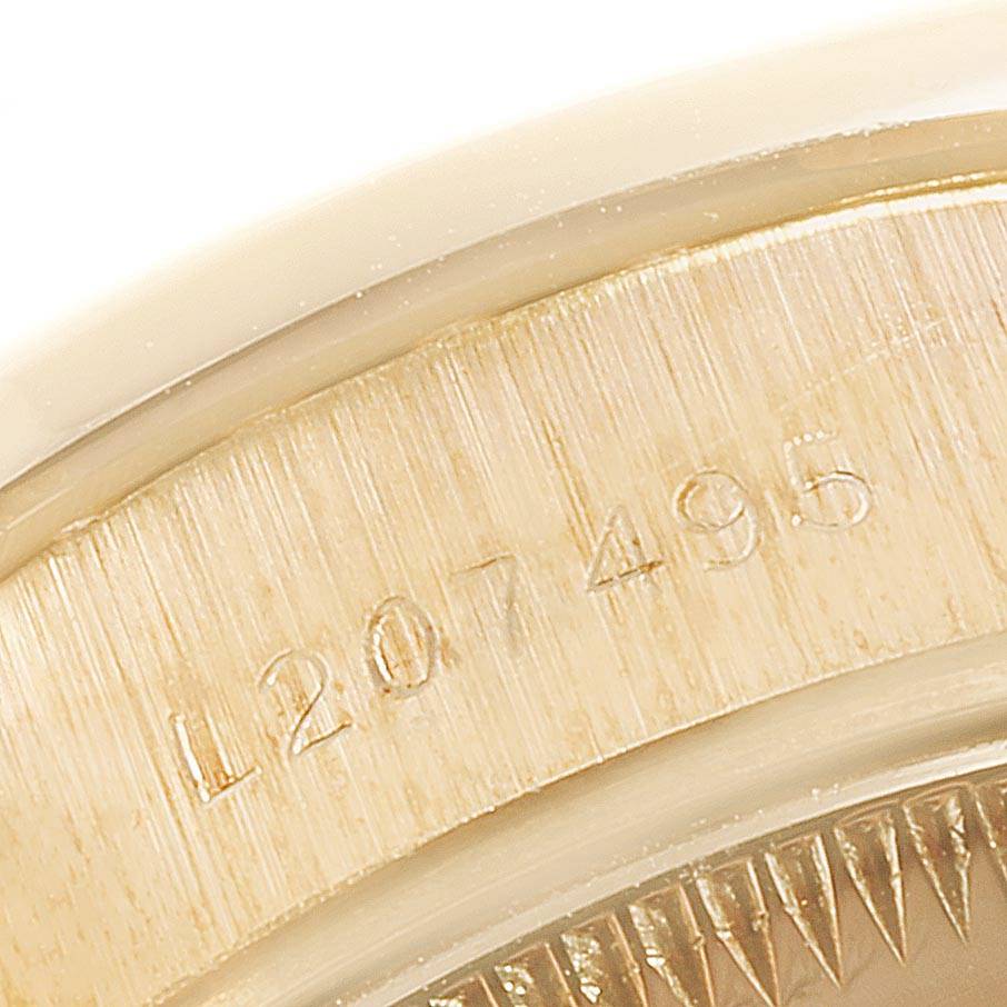 The image shows the side view and serial number engraving on the caseback of the Rolex President 69138 Women
s Yellow Gold Champagne Dial 69138 Women
s Yellow Gold Champagne Dial model watch.