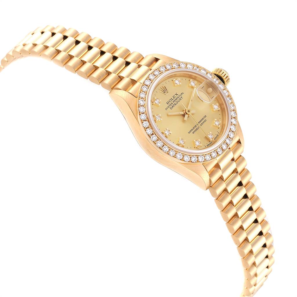 The Rolex President 69138 Women
s Yellow Gold Champagne Dial 69138 Women
s Yellow Gold Champagne Dial model watch is shown at a slight angle, highlighting the diamond bezel, yellow gold case, and gold bracelet.