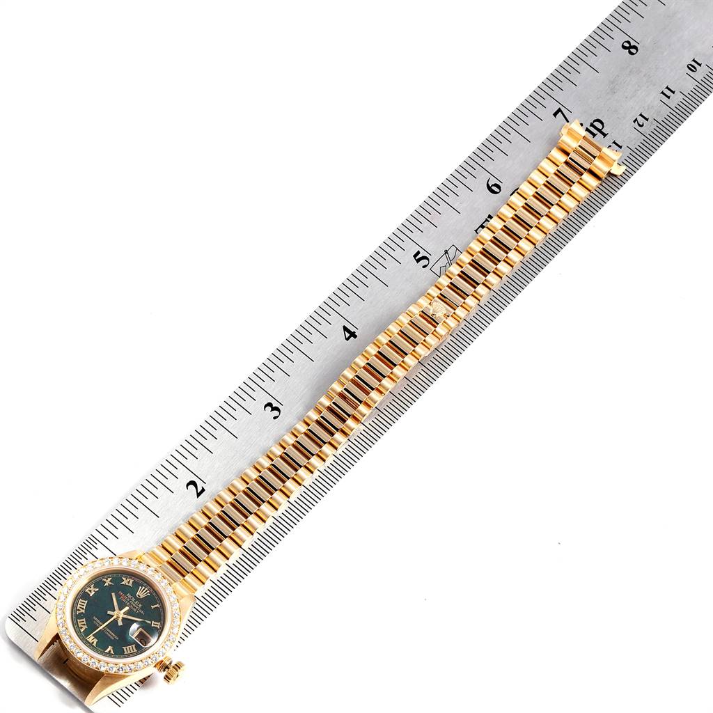 The image shows a Rolex President 69138 Women's Yellow Gold Champagne Dial 69138 Women's Yellow Gold Champagne Dial model watch laid flat alongside a ruler, displaying the face and full bracelet.