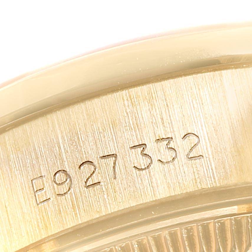 This is a close-up view of the serial number engraved on the case of a Rolex President 69138 Women's Yellow Gold Champagne Dial 69138 Women's Yellow Gold Champagne Dial model watch.