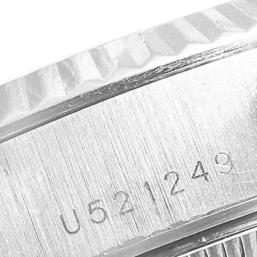 This close-up shows the engraved serial number on the case edge of a Rolex President 69179 Women's White Gold Silver Dial 69179 Women's White Gold Silver Dial model watch, highlighting the fluted bezel.