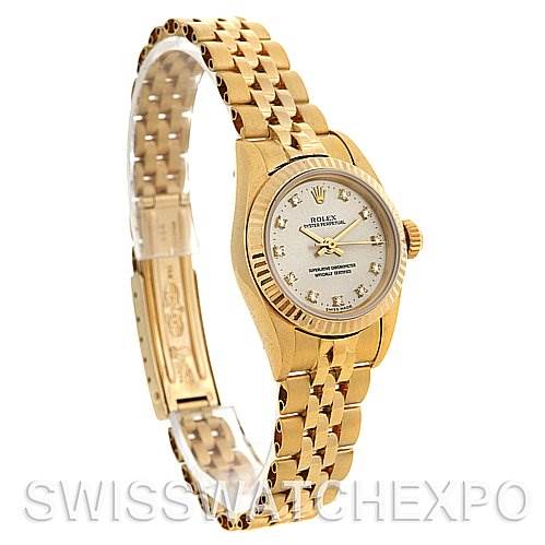 The image shows a side angle of a Rolex President 67197 Women's Yellow Gold Silver Dial 67197 Women's Yellow Gold Silver Dial model watch, highlighting the gold bracelet, face, bezel, and crown.