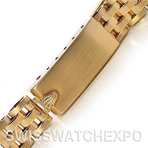 This image shows the clasp of a Rolex President 67197 Women's Yellow Gold Silver Dial 67197 Women's Yellow Gold Silver Dial model watch at a close-up, with the brand's logo engraved on it.