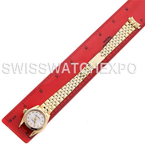 The image shows a President model Rolex watch placed next to a red ruler, highlighting its full length and bracelet details.