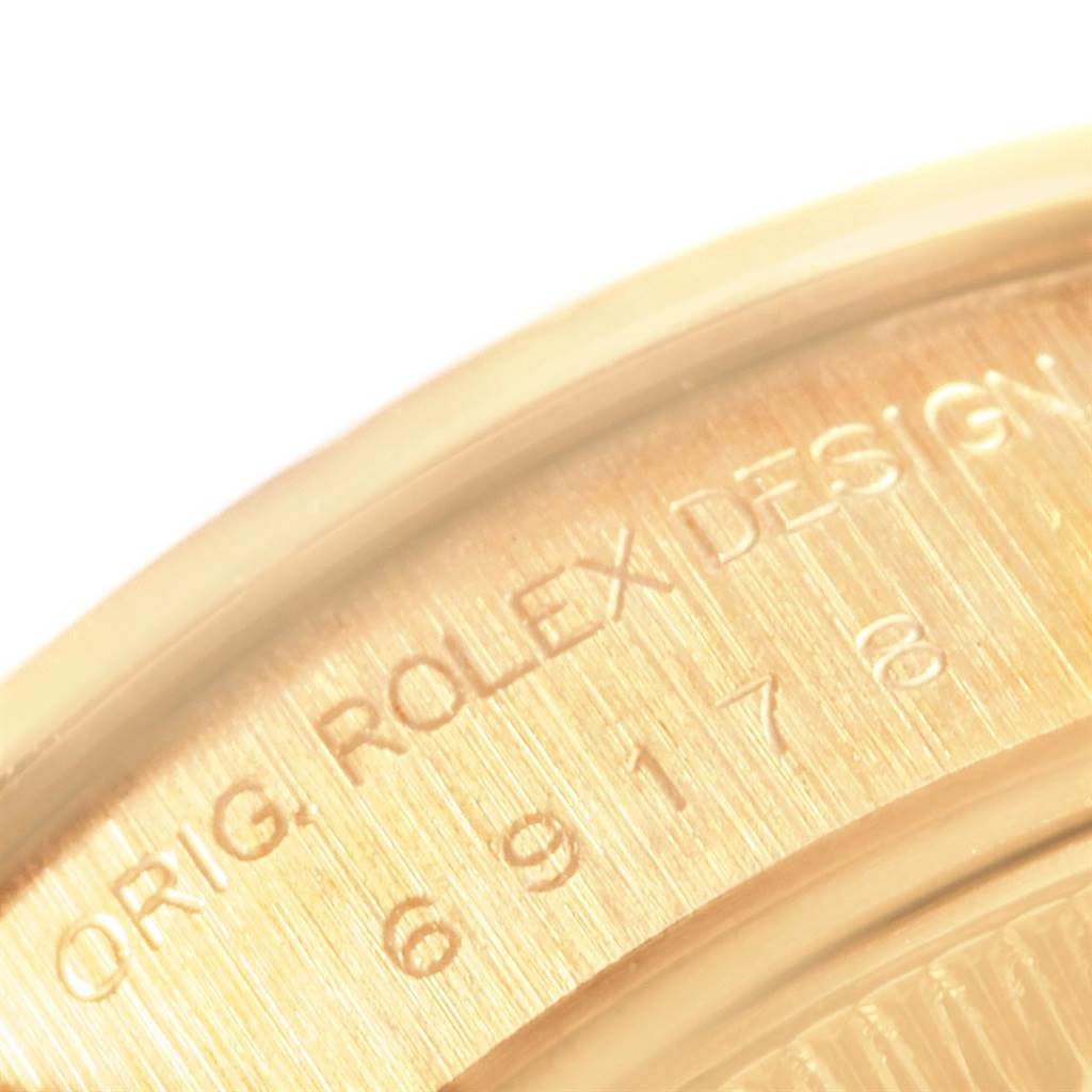 This close-up image shows the engraving on the case back of a Rolex President 69178 Women's Yellow Gold Champagne Dial 69178 Women's Yellow Gold Champagne Dial model watch.