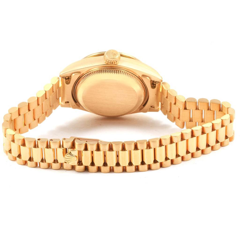 This image shows the back view of a Rolex President 69178 Women's Yellow Gold Champagne Dial 69178 Women's Yellow Gold Champagne Dial model watch, featuring its gold case and bracelet.