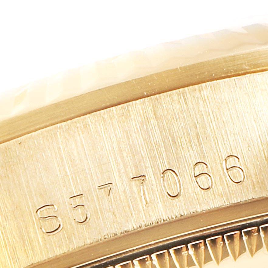 This close-up image shows the engraved serial number on the case edge and part of the bezel of a Rolex President 68278 Women's Yellow Gold White Dial 68278 Women's Yellow Gold White Dial model watch.