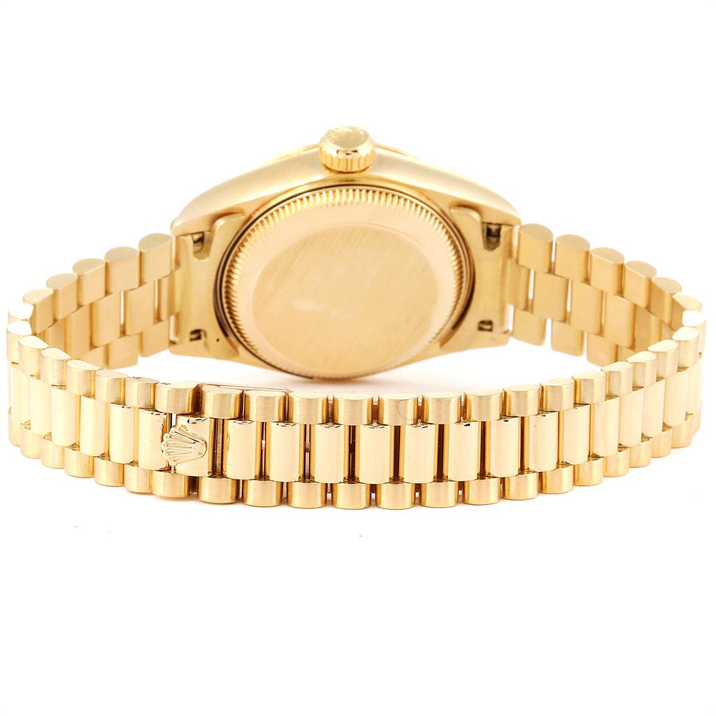 The image shows the back of the Rolex President 69178 Women's Yellow Gold Champagne Dial 69178 Women's Yellow Gold Champagne Dial watch, highlighting its case and gold bracelet with the Rolex crown logo.