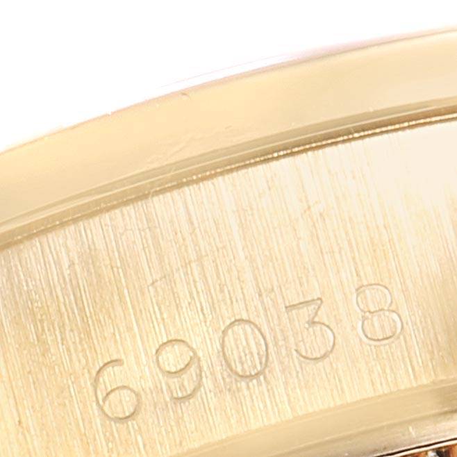 The image shows a close-up of the inside engraving on a Rolex President 69038 Women
s Yellow Gold Champagne Dial 69038 Women
s Yellow Gold Champagne Dial model, displaying the number 69038.