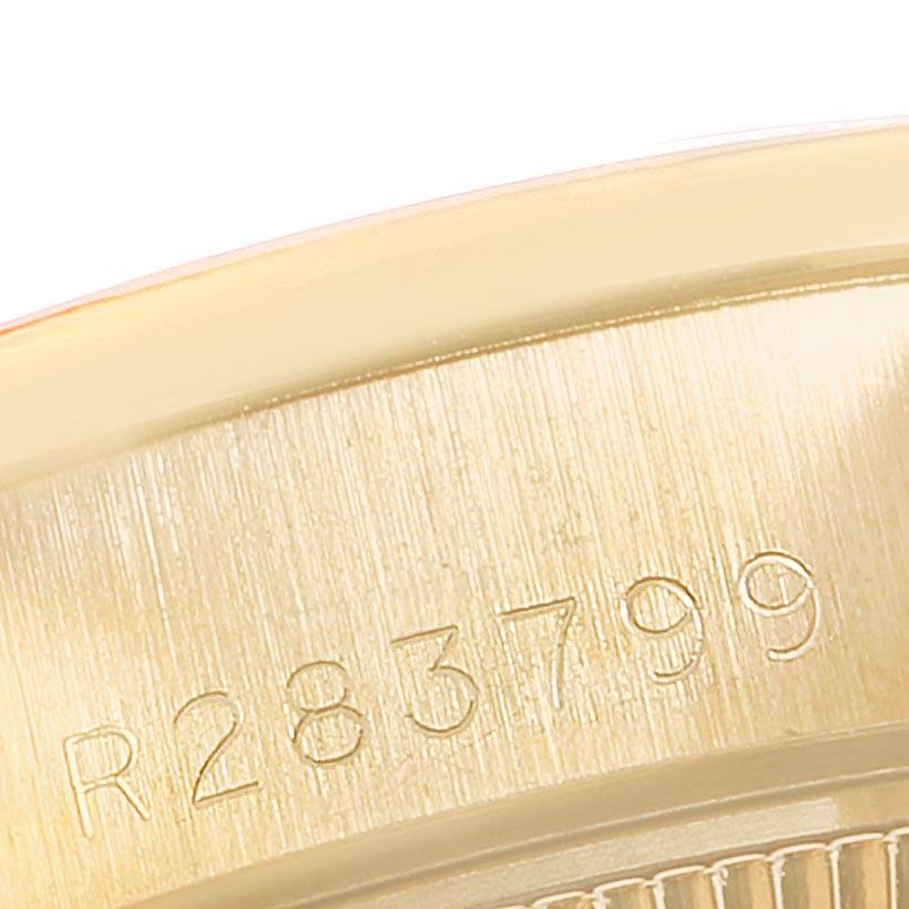 This close-up image shows the serial number on the gold bezel of a Rolex President 69038 Women
s Yellow Gold Champagne Dial 69038 Women
s Yellow Gold Champagne Dial watch.