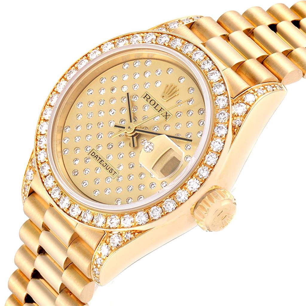 The image shows a Rolex President 69038 Women
s Yellow Gold Champagne Dial 69038 Women
s Yellow Gold Champagne Dial model watch from an angled close-up, highlighting the diamond-studded bezel, dial, and bracelet links.
