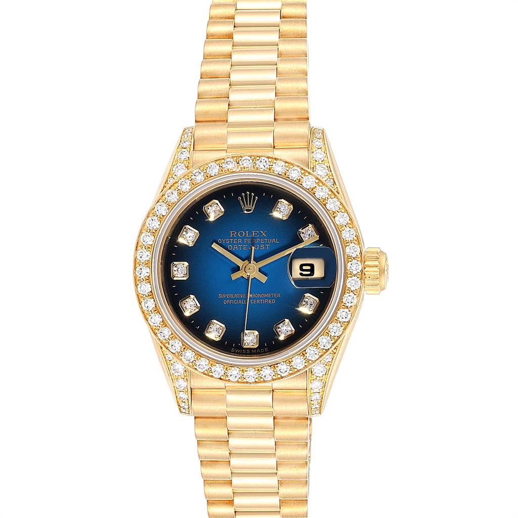 The Rolex President 69158 Women's Yellow Gold Blue Dial 69158 Women's Yellow Gold Blue Dial model watch is shown from a top-down angle, featuring a gold band, a blue dial, a date window, and a diamond-studded bezel.