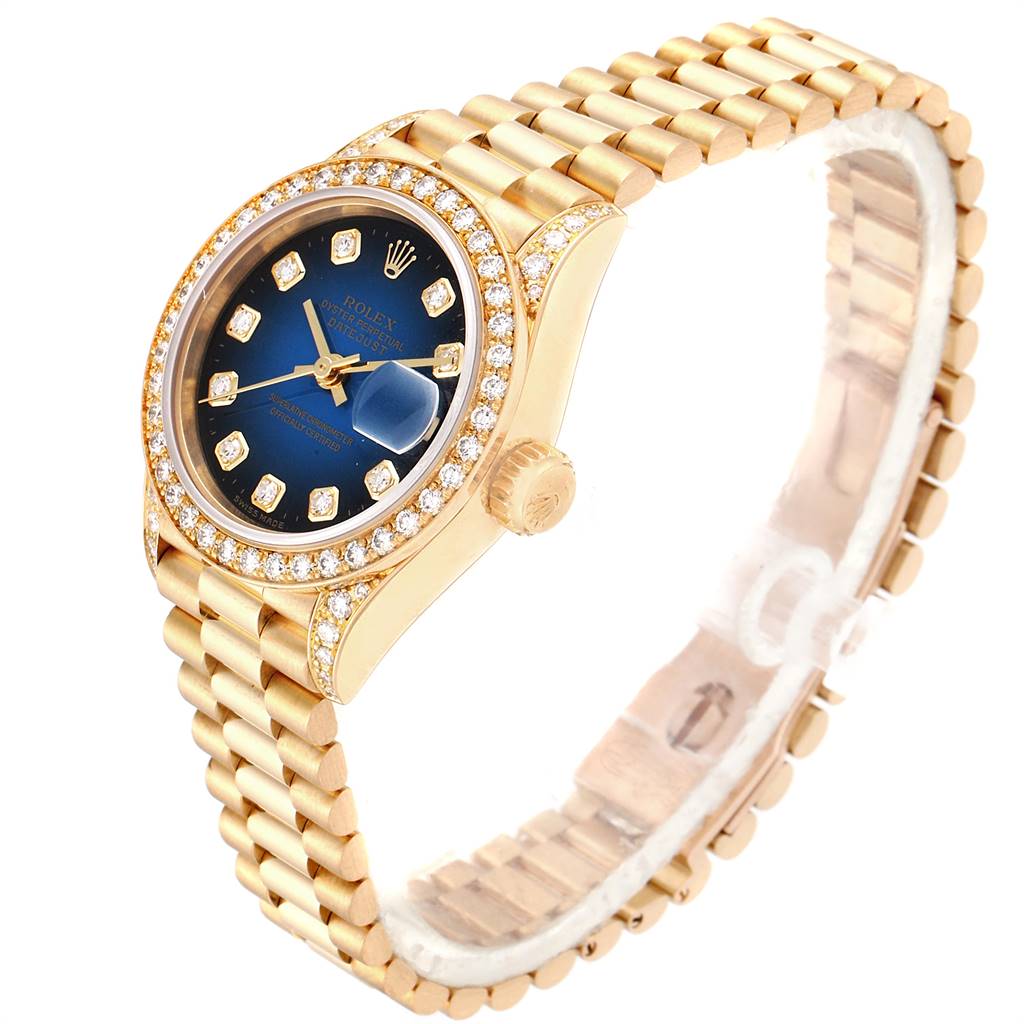 The image shows a Rolex President 69158 Women's Yellow Gold Blue Dial 69158 Women's Yellow Gold Blue Dial model watch angled from the top right, displaying the dial, bezel, crown, and bracelet.