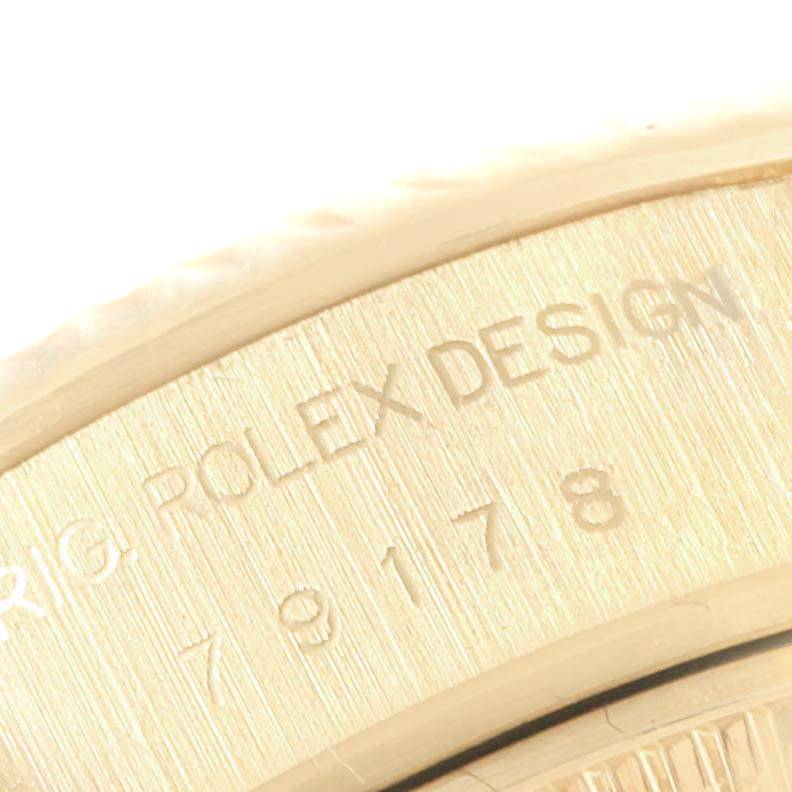 The image shows an up-close view of the engraved "ROLEX DESIGN" on the case back of a Rolex President 79178 Women's Yellow Gold Champagne Dial 79178 Women's Yellow Gold Champagne Dial model watch.