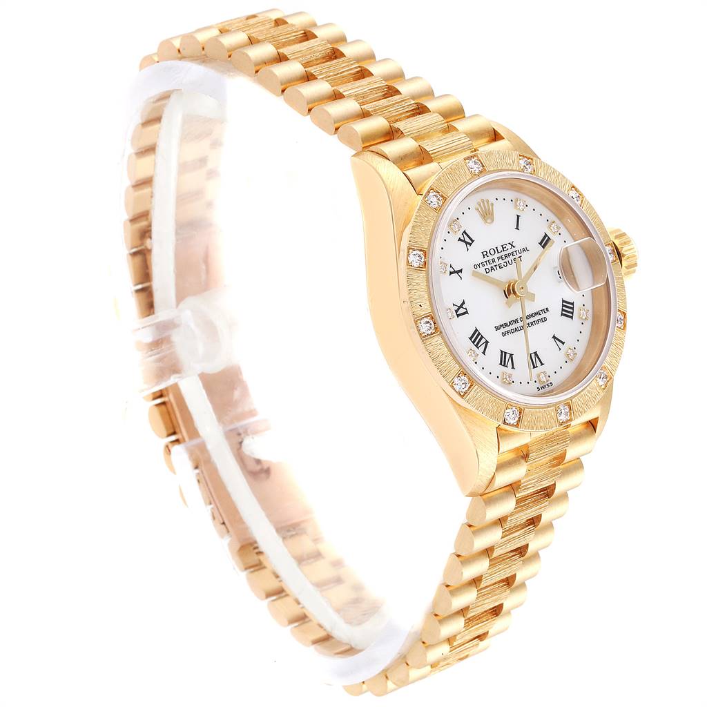 This image shows a Rolex President 69288 Women
s Yellow Gold White Dial 69288 Women
s Yellow Gold White Dial model watch at a slight angle, highlighting the gold bracelet, bezel with diamonds, dial, and crown.
