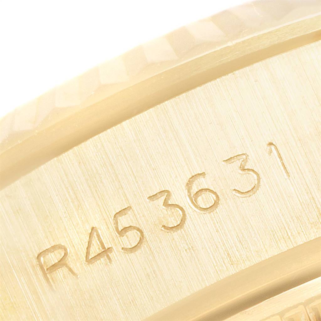 This image shows a close-up view of the engraved serial number on the side of a Rolex President 69178 Women's Yellow Gold Blue Dial 69178 Women's Yellow Gold Blue Dial model watch case.