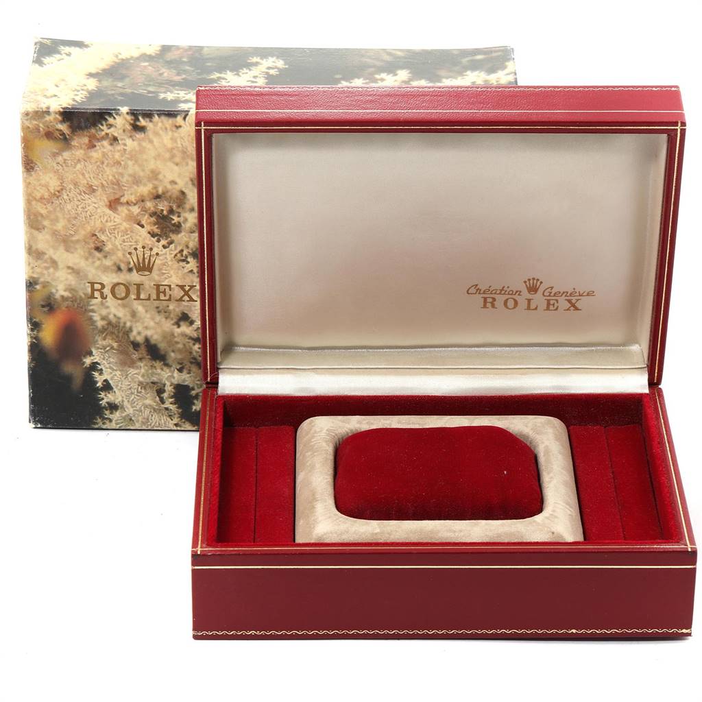 This image shows an open Rolex President 69178 Women's Yellow Gold Blue Dial 69178 Women's Yellow Gold Blue Dial model watch box with a cushion inside, revealing the interior branding.