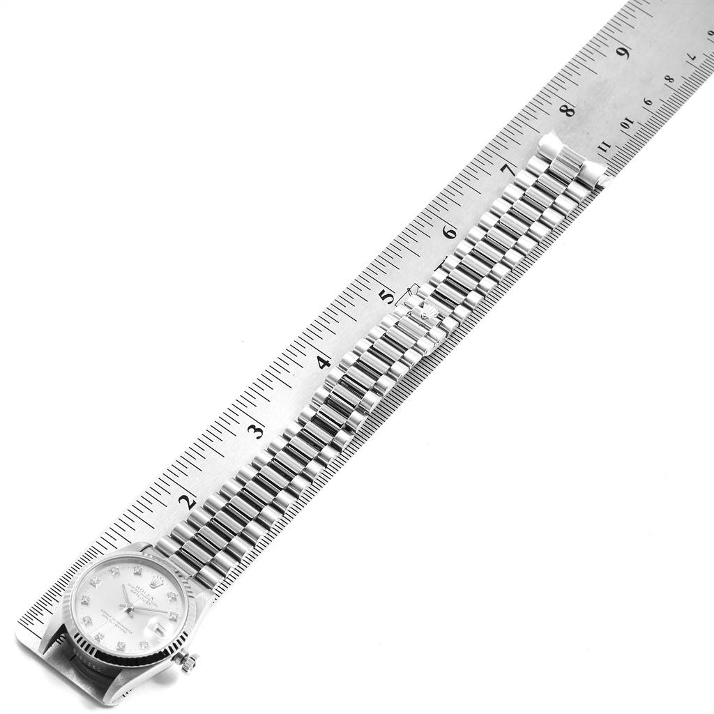 The image shows a Rolex President 68279 Women's White Gold Silver Dial 68279 Women's White Gold Silver Dial model watch laying flat with the dial and bracelet visible, next to a ruler for measurement.