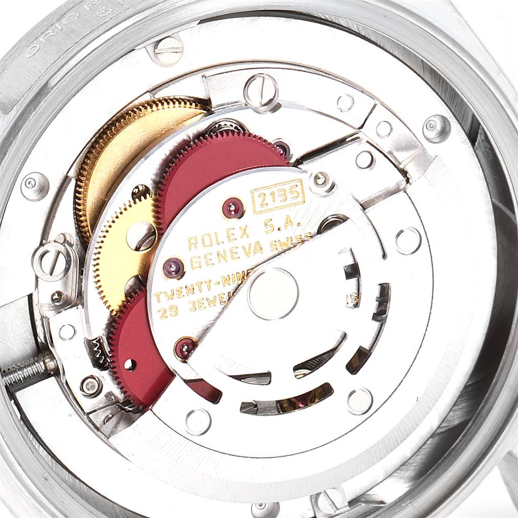 An internal view of the Rolex President 68279 Women's White Gold Silver Dial 68279 Women's White Gold Silver Dial model watch showing its intricate mechanical movement components and engravings.