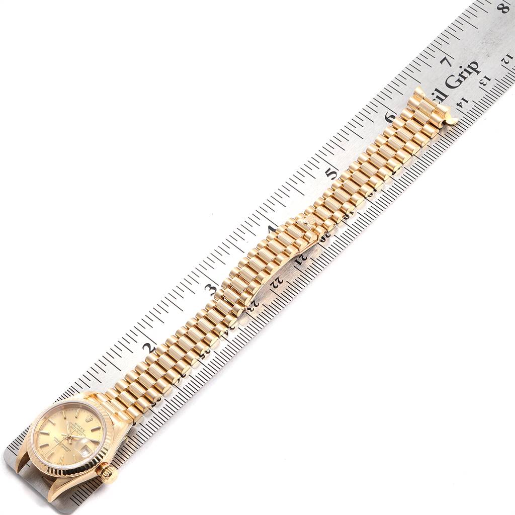 The image shows the dial, case, and band of a Rolex President 79178 Women
s Yellow Gold Champagne Dial 79178 Women
s Yellow Gold Champagne Dial model watch, aligned with a ruler for measurement.