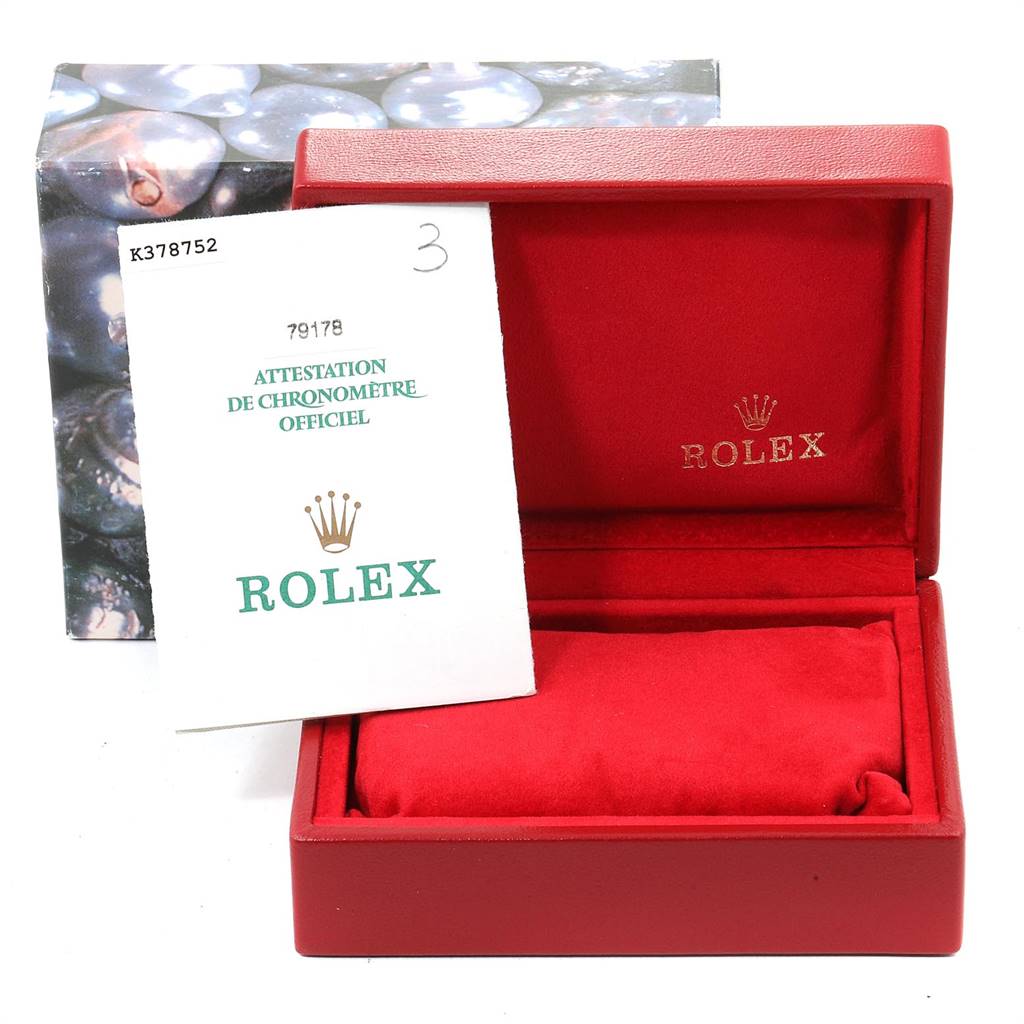 The image shows a Rolex President 79178 Women
s Yellow Gold Champagne Dial 79178 Women
s Yellow Gold Champagne Dial model
s red watch box, open, with papers including an "Attestation de Chronomètre Officiel."