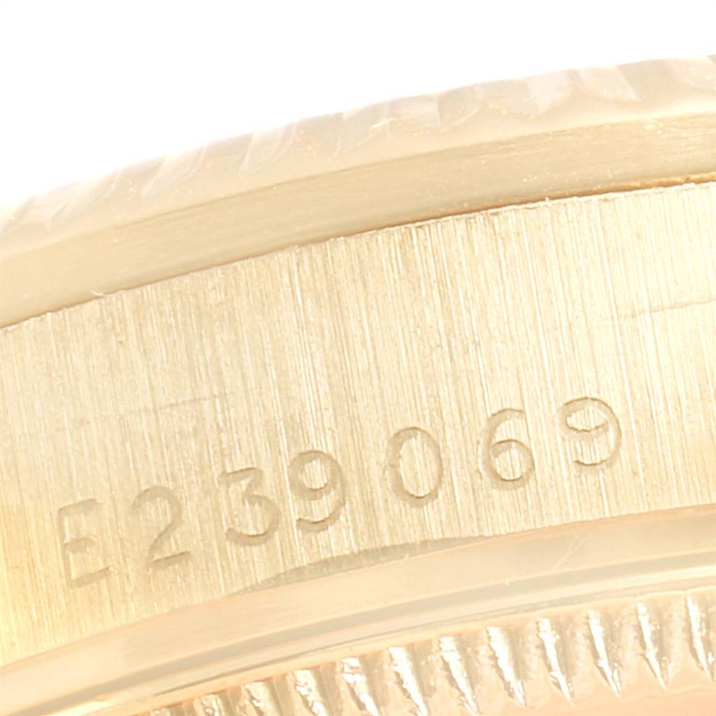 This close-up image shows the serial number engraved on the side case of a Rolex President 68278 Women
s Yellow Gold White Dial 68278 Women
s Yellow Gold White Dial model watch.