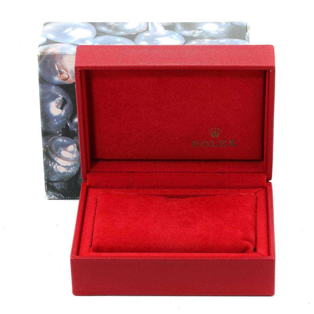 The image shows a red Rolex watch box for the President model, opened to display the interior and a cushion.