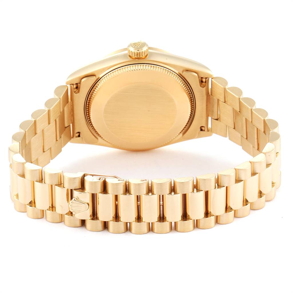The image shows the back and bracelet of a Rolex President 68278 Women
s Yellow Gold White Dial 68278 Women
s Yellow Gold White Dial model watch, highlighting its gold casing and band.