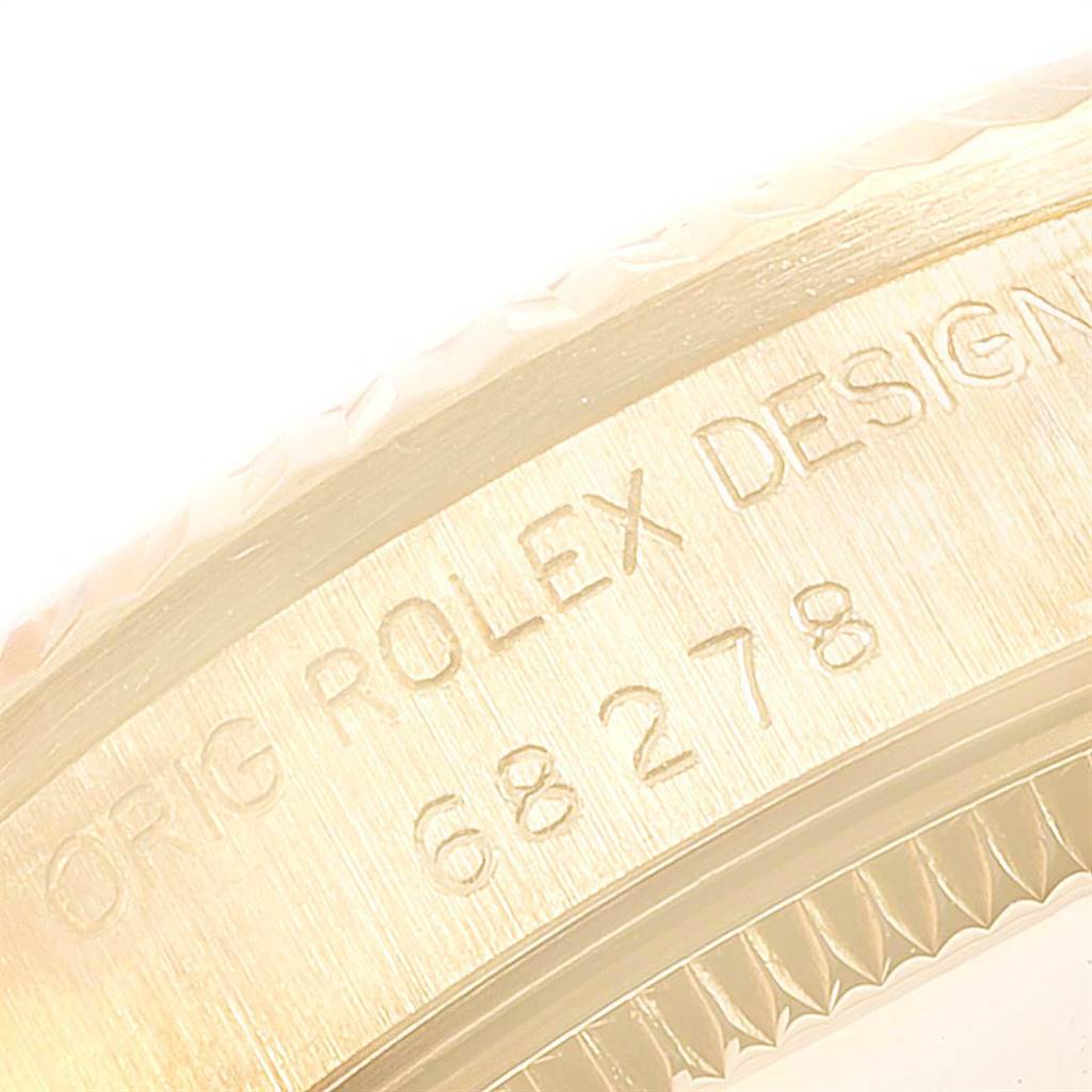 The image shows a close-up of the engraving on the side of a Rolex President 68278 Women
s Yellow Gold White Dial 68278 Women
s Yellow Gold White Dial watch case.