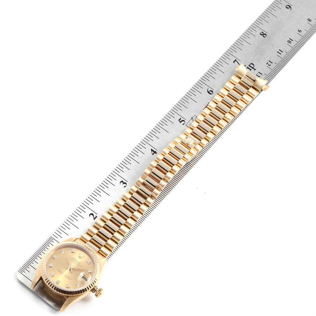 The Rolex President 68278 Women
s Yellow Gold Champagne Dial 68278 Women
s Yellow Gold Champagne Dial model watch is shown from a top-down angle, displaying the face, bracelet, and a ruler for scale.