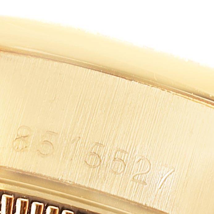 This close-up image shows the serial number engraving on the inner side of the bezel of a Rolex President 69138 Women's Yellow Gold Blue Dial 69138 Women's Yellow Gold Blue Dial watch.