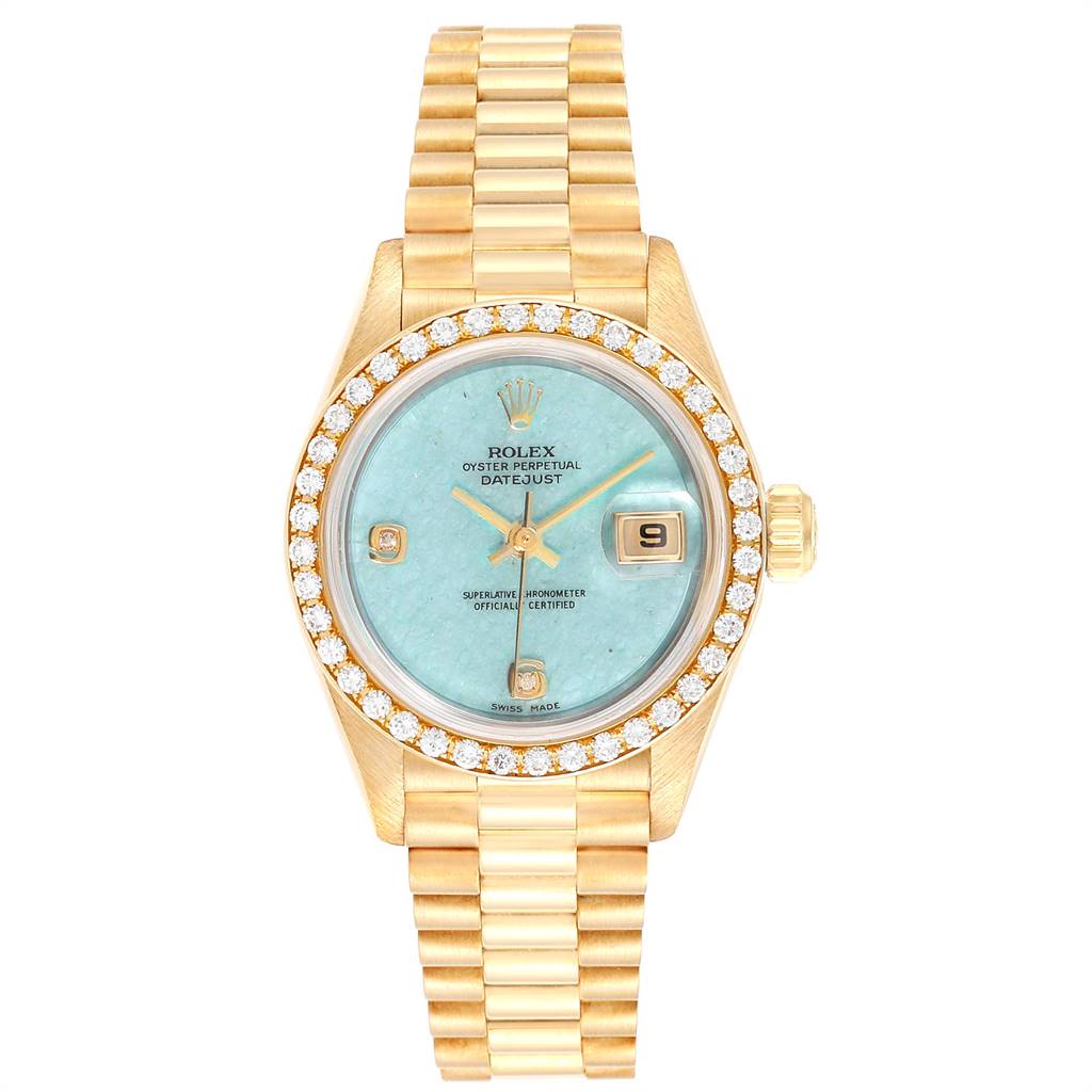 The image shows a frontal view of a Rolex President 69138 Women's Yellow Gold Blue Dial 69138 Women's Yellow Gold Blue Dial model watch with a gold bracelet, turquoise dial, and diamond bezel.
