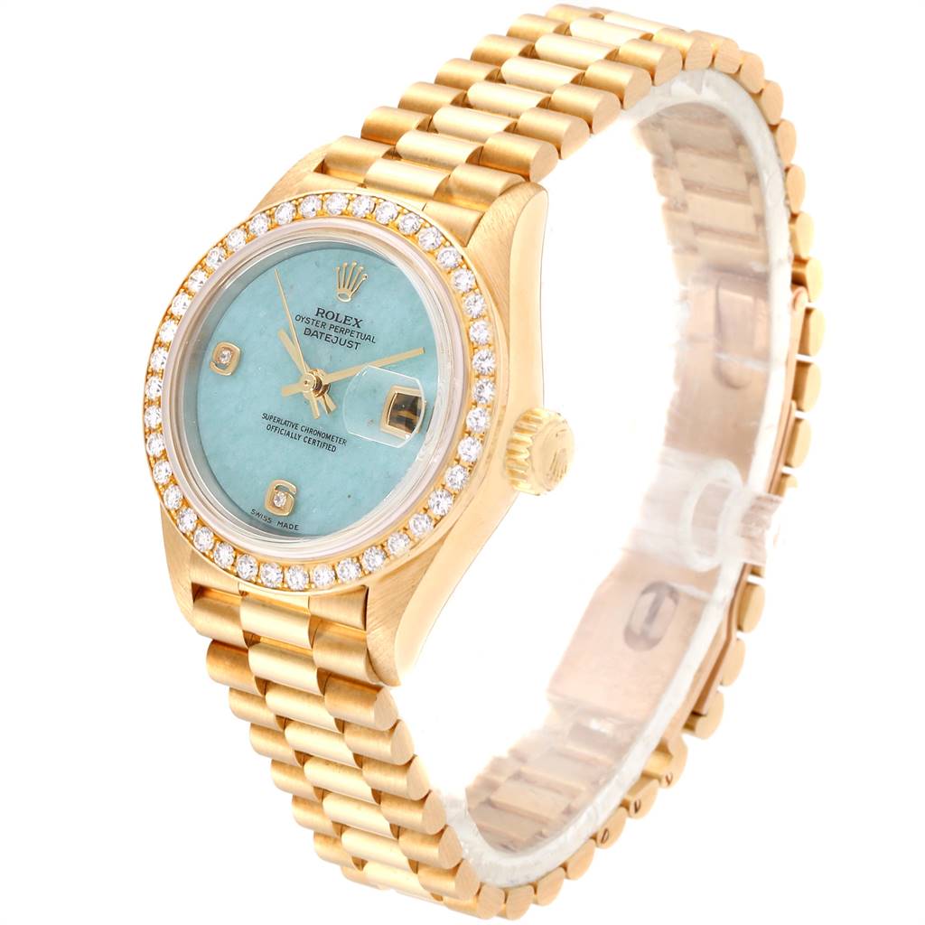 The image shows a Rolex President 69138 Women's Yellow Gold Blue Dial 69138 Women's Yellow Gold Blue Dial model watch at an angled view, highlighting its face, bezel, crown, and bracelet.