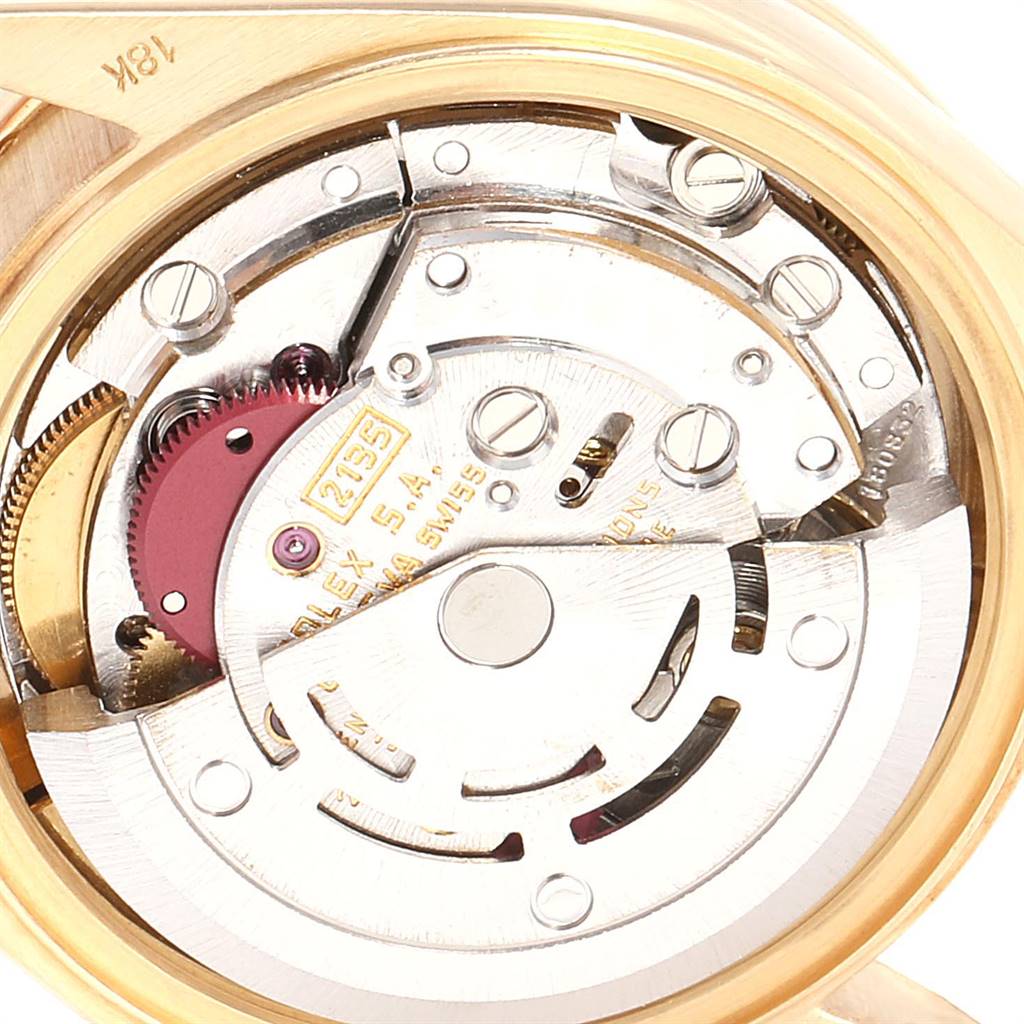 The image shows a close-up view of the movement inside a Rolex President 69138 Women
s Yellow Gold Champagne Dial 69138 Women
s Yellow Gold Champagne Dial model watch, highlighting its intricate inner workings.