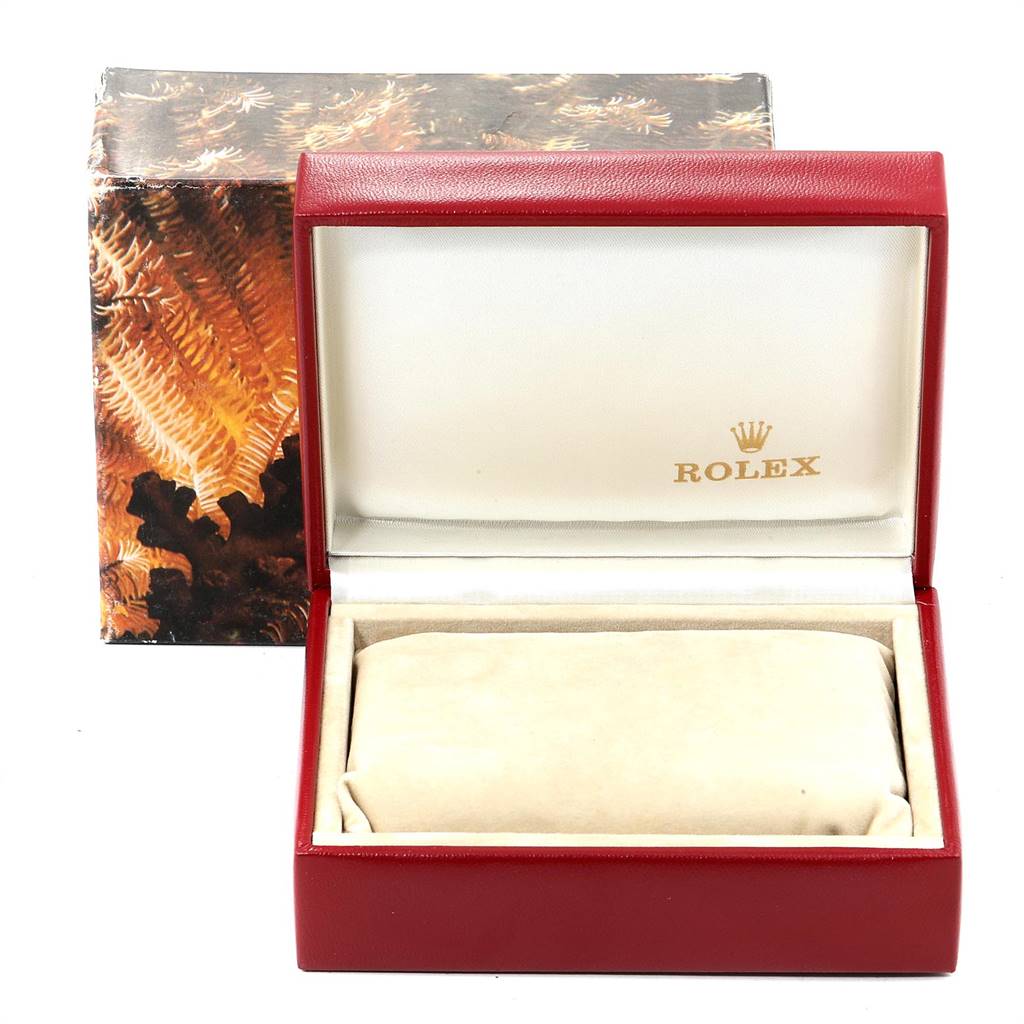 This image shows an open Rolex President 68278 Women
s Yellow Gold Champagne Dial 68278 Women
s Yellow Gold Champagne Dial watch box, featuring its interior lining and logo, accompanied by an outer decorative box.