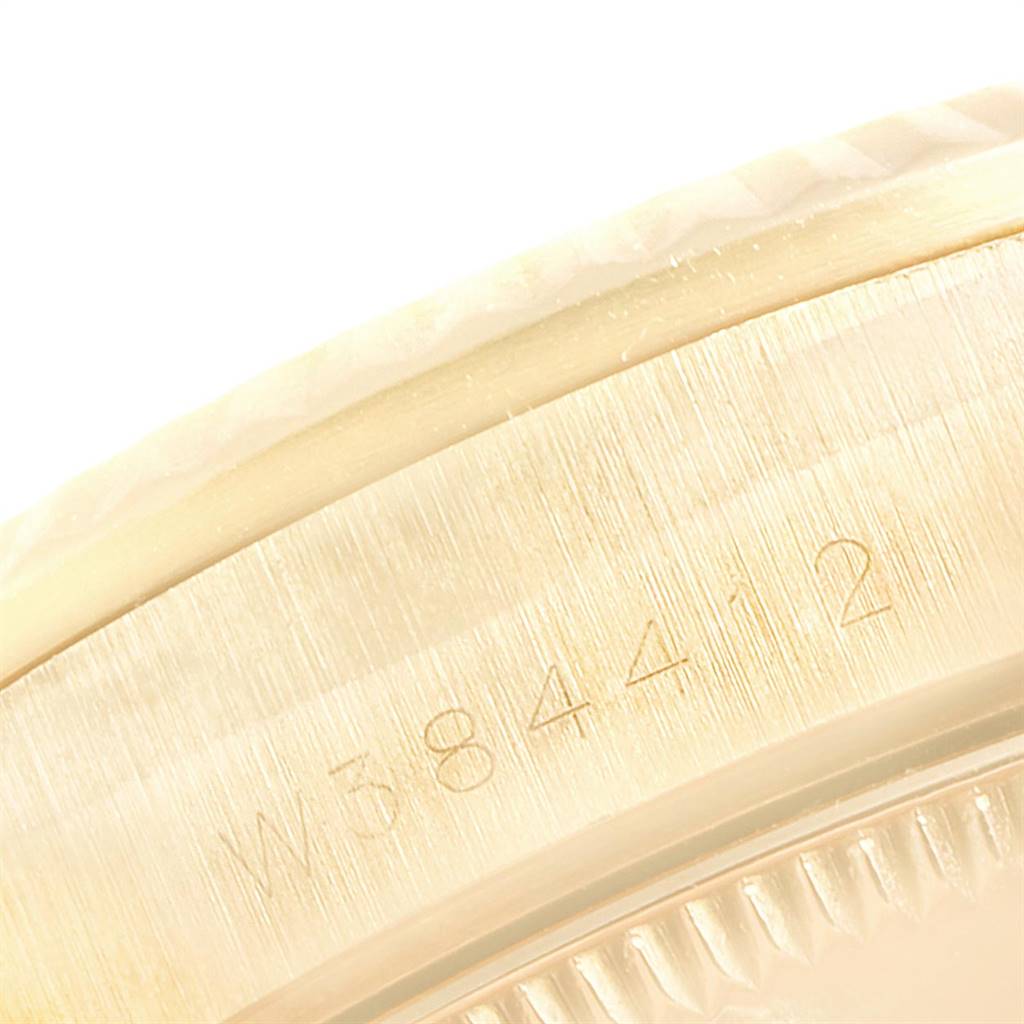 This close-up shows the side of the case of a Rolex President 68278 Women
s Yellow Gold Champagne Dial 68278 Women
s Yellow Gold Champagne Dial watch, including the serial number engraving.