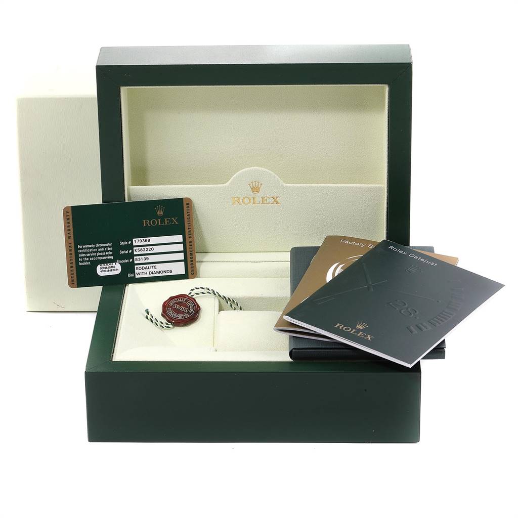 This image shows the packaging and accessories of a Rolex President 179369 Women's White Gold Blue Dial 179369 Women's White Gold Blue Dial model, including the box, manual, tag, and warranty card.