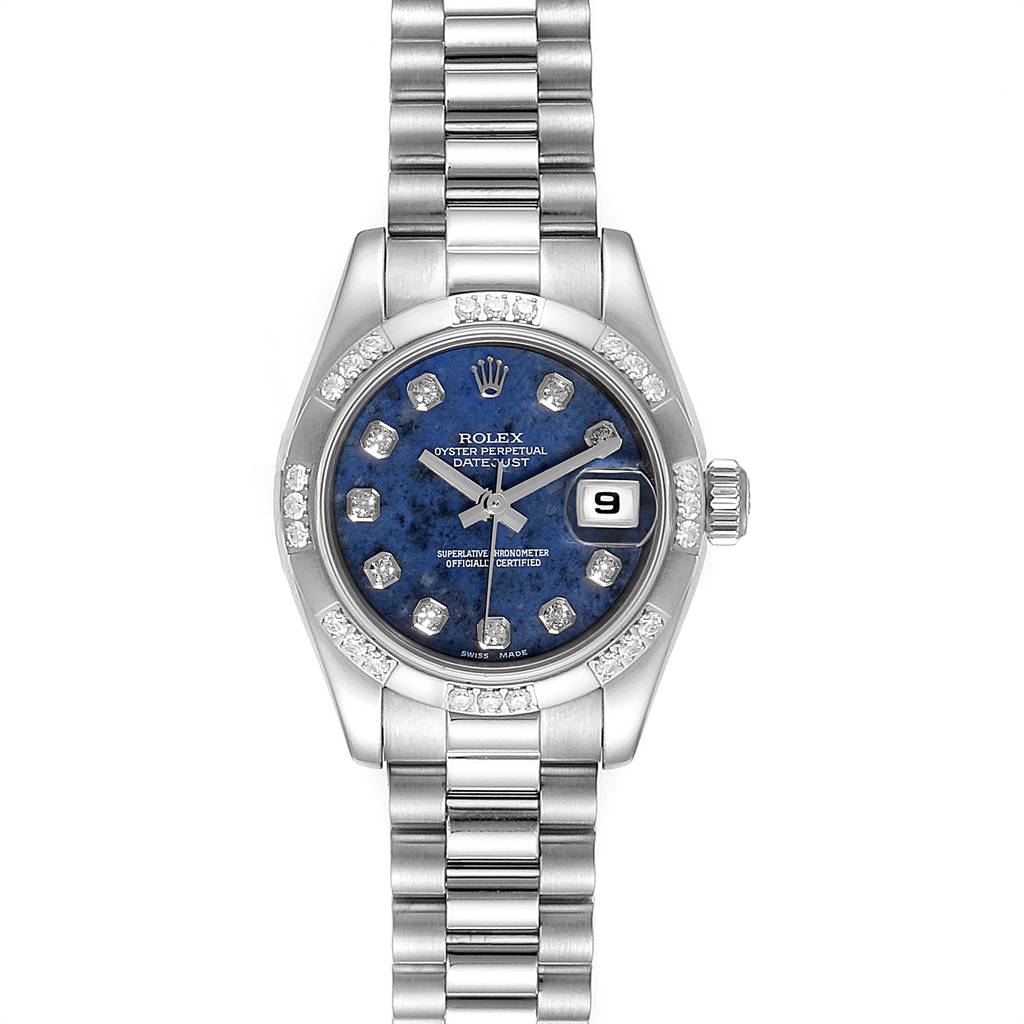 The Rolex President 179369 Women's White Gold Blue Dial 179369 Women's White Gold Blue Dial model watch is shown from a top-down angle, featuring a blue dial, date window, diamond hour markers, and a metal bracelet.