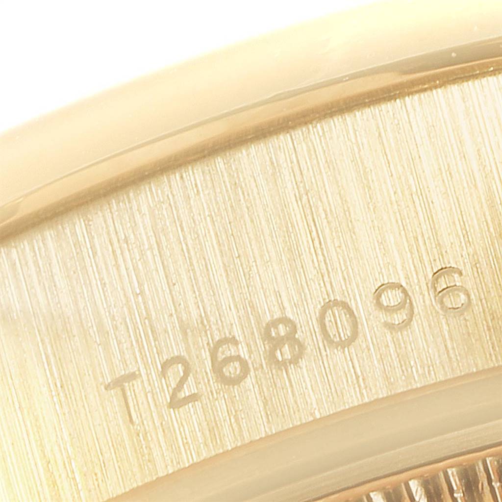 This image shows a close-up of a partial serial number engraved on the gold case of a Rolex President 69138 Women
s Yellow Gold Champagne Dial 69138 Women
s Yellow Gold Champagne Dial model watch.