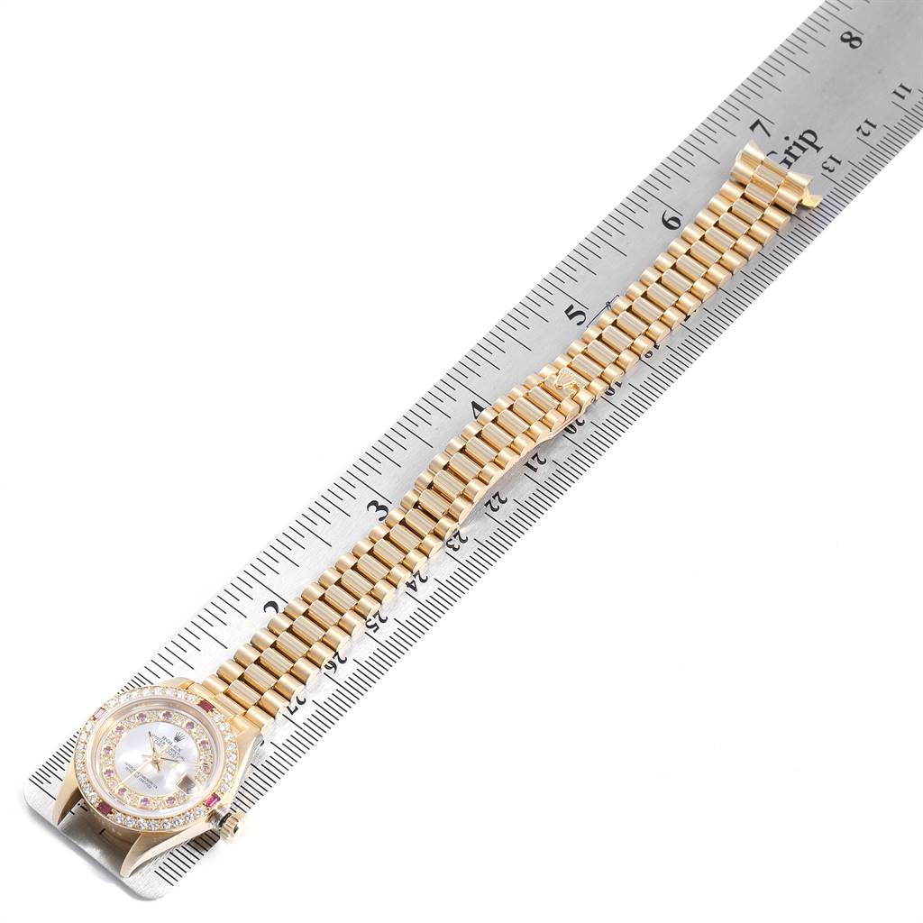 The Rolex President 69068 Women
s Yellow Gold Mother of Pearl Dial 69068 Women
s Yellow Gold Mother of Pearl Dial model is shown laid flat with the face, bezel, and bracelet visible against a ruler for measurement.