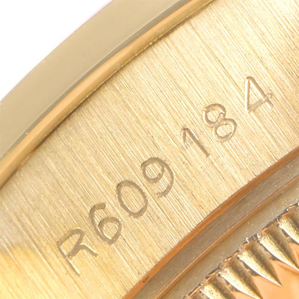 This close-up shows the serial number engraved on the case of a Rolex President 69068 Women
s Yellow Gold Mother of Pearl Dial 69068 Women
s Yellow Gold Mother of Pearl Dial model watch.